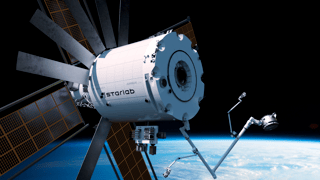 Starlab commercial space station with solar arrays and robotic arm above Earth